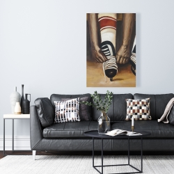 Canvas 24 x 36 - Hockey player ties his skates