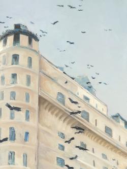 Birds flying in front of a building