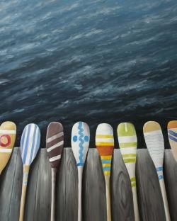 Colorful paddles on the dock