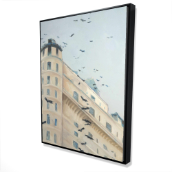Birds flying in front of a building